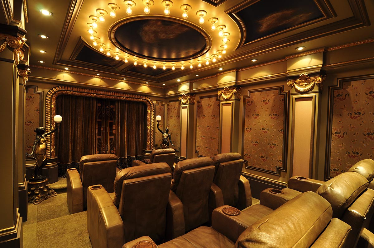 Dimly lit luxury home theater with curtains covering the screen